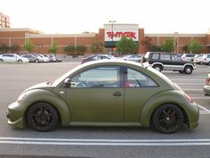 a green car parked in a parking lot