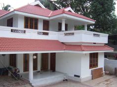 a large white house with red roof tiles