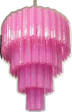 a large pink chandelier hanging from a ceiling fixture with plastic covering on it