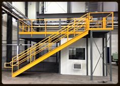 a yellow stair case in an industrial building