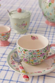 a tea cup and saucer on a table