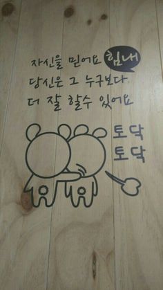 a wooden floor with writing on it and an image of a mouse drawn on the wood