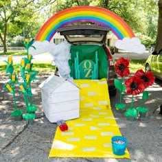 the trunk of a car is decorated with flowers and other decorations for an outdoor event