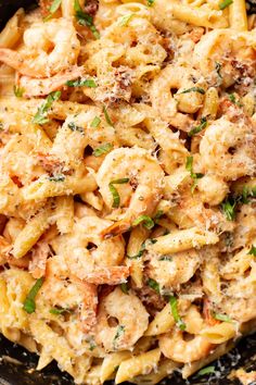 pasta with shrimp and parmesan cheese in a skillet ready to be eaten