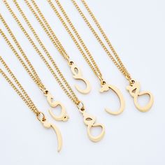 The iconic Arabic Letter has helmed Nominal for half a decade. This all new variation delivers a timeless way to represent yourself or a loved one. Your identity in one hanging letter, brought together by an elegant curb chain, meant for meaningful everyday wear. Click here to shop our matching Men's Hanging Letter Necklace. Materials & Warranty Necklace Length: 16 Inch Chain + 6 Inch Extension (22 inches total) | Extensions are available here. Material: Premium Stainless Steel, dipped in real 1 Gold Name Necklace Arabic, Gold Arabic Necklace, Arabic Letter Necklace, Arabic Calligraphy Necklace, Arabic Name Necklace, Arabic Letters, Locket Design, Hanging Letters, Necklace Women