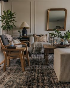 a living room filled with furniture and a large mirror