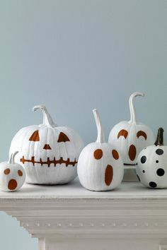 white pumpkins decorated with orange and black polka dots