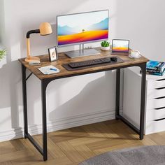 a computer desk with a monitor, keyboard and mouse on it in front of a white wall