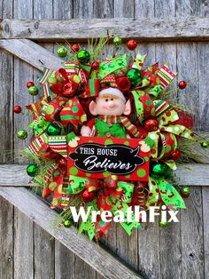 a christmas wreath with a teddy bear on it