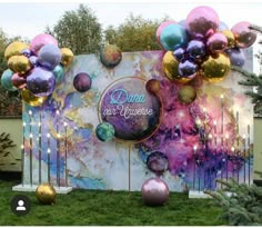 balloons and streamers are on display in front of a backdrop