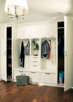 an organized closet with white cabinets and drawers