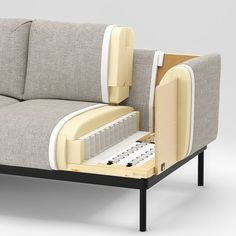 a couch with an open drawer on the back and bottom part in white, beige and black