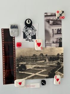 an assortment of playing cards, dices and magnets attached to a wall with pictures on it