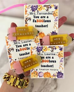 three teacher magnets with gold lettering on them and some pink ones in the middle