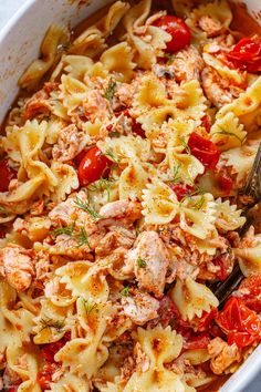 a white bowl filled with pasta and meat