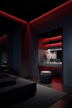 a dark room with red lighting on the walls and furniture in the center, along with a large bed