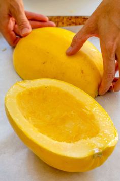 someone is peeling the inside of a squash