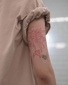 a woman's arm with a flower tattoo on the left side of her arm