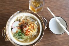 a bowl filled with soup next to a drink