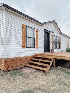 a mobile home with steps leading to the front door