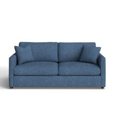 a blue couch sitting on top of a white floor