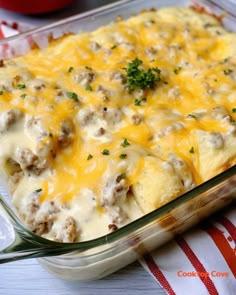 a casserole dish with meat and cheese in it on a red and white towel