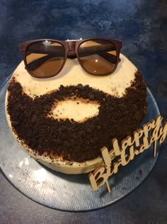 a birthday cake with sunglasses on top of it