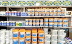 the shelves are filled with many different types of water and other items in plastic containers