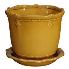 a yellow planter sitting on top of a saucer