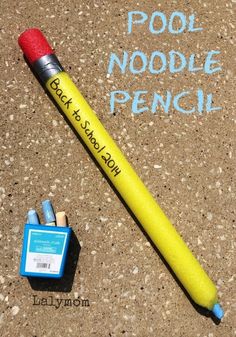 a pencil and eraser sitting on the ground next to a sign that says pool noodle french