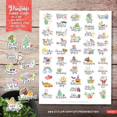 the christmas planner stickers are shown next to a potted plant on a wooden table