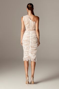 Fatima' exudes elegance and romance, particularly stunning in a delicate off-white hue. This dress features a delicate overlay of floral lace, gracefully scalloped at the neckline, and backed with our special Jersey fabric for modest coverage. The cinched-in fit and waistband emphasize a slender waistline, adding to its flattering silhouette.The skirt of 'Fatima' is elegantly ruched and fully lined with nude soft Jersey, cascading to an ultra-classy midi length. For ease of wear, it zips up at t Ruched Midi Dress, Jersey Fabric, Floral Lace, Midi Length, Zip Ups, Midi Dress, Romance, Off White, Skirt