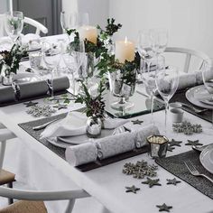 a table set for christmas dinner with place settings