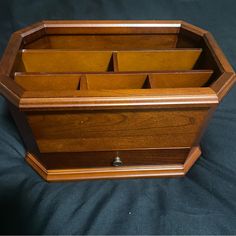 a wooden box that has compartments in it