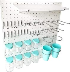 a wall mounted rack with cups and spoons