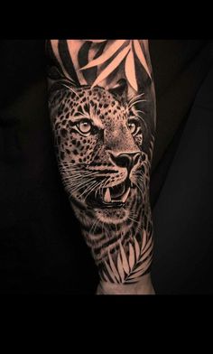 a man's arm with a black and white tattoo design on it, depicting a leopard