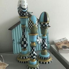 three blue and black vases sitting on top of a table