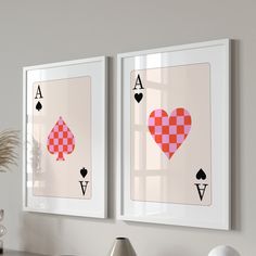 two framed playing cards with hearts and spades