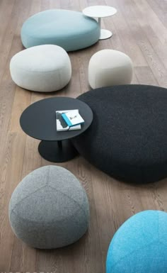 several different colored stools and tables on the floor