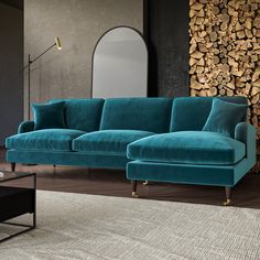 a large blue couch sitting in front of a mirror