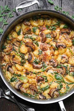 a pan filled with food on top of a wooden table