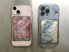 two cell phones sitting next to each other on top of a metal surface with stickers