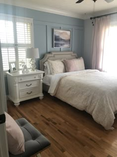 a bed sitting in a bedroom next to a window