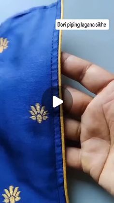 someone is stitching something on the side of a blue jacket with gold pineapples