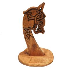 a wooden horse head on top of a stand