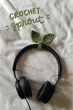 a pair of headphones laying on top of a white sheet with the words crochet sprout