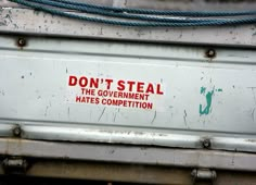 a sign on the back of a truck that says don't steal the government hates competition