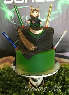 a cake that is sitting on top of a green plate with two swords in it