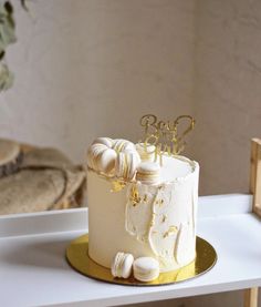 a white and gold wedding cake on a table