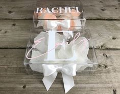 a clear box that has some kind of cake in it with the name rachel on it